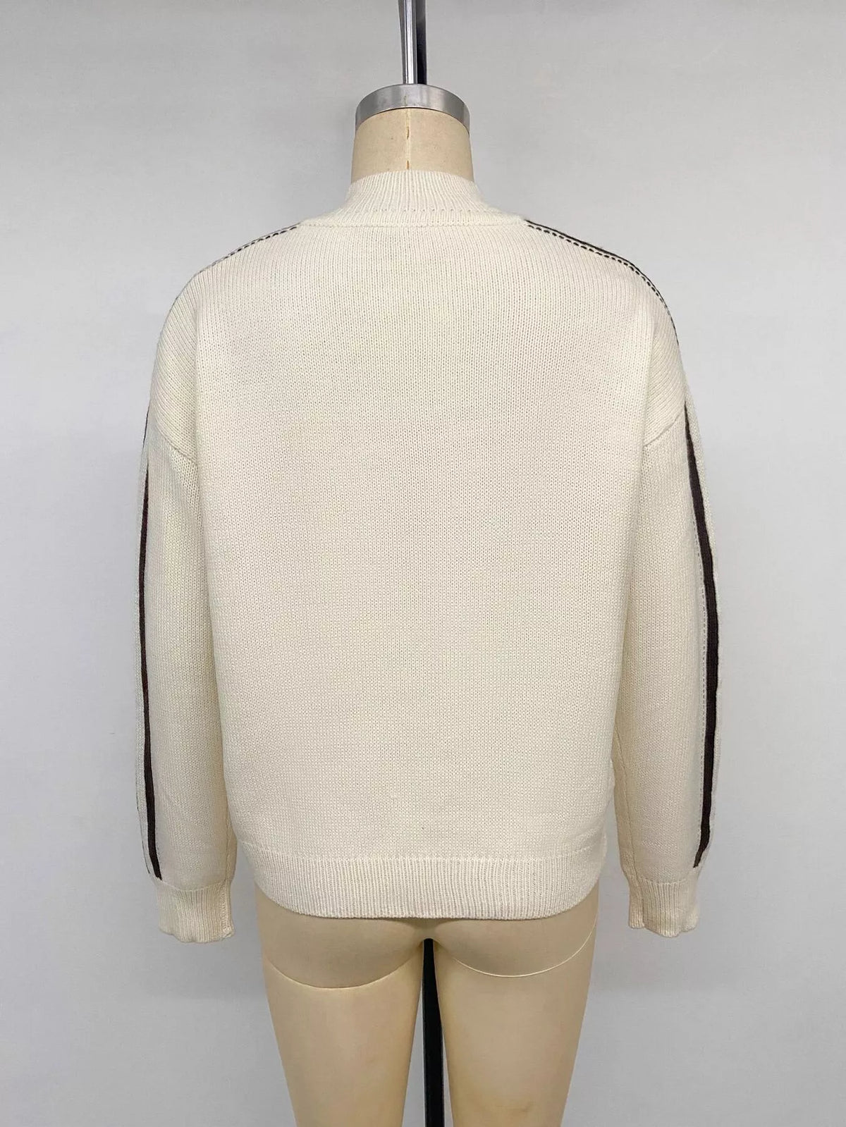 View 14 of the cardigan with Chinese knot buttons and contrast stripes down the sides.