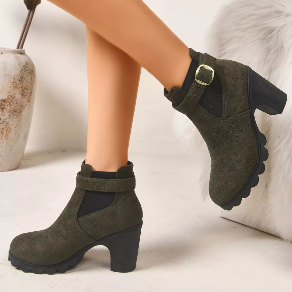 View 7 of the suede boots with a round toe and a high block heel.